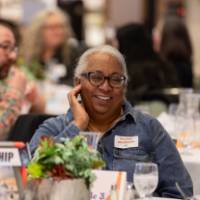 person at table smiling